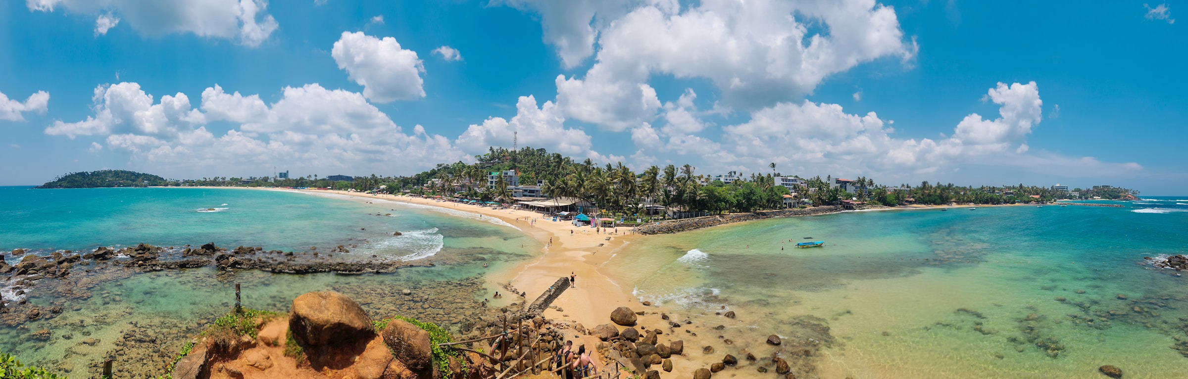 Golden beach and blue water in Mirissa